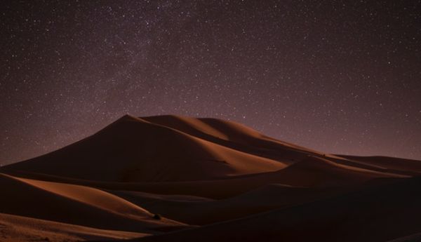 Desert dunes under starry sky